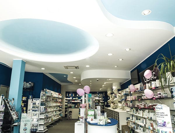 Interno di una farmacia con scaffali e prodotti esposti.